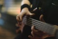 Man bass guitarist playing electrical guitar on concert stage Royalty Free Stock Photo