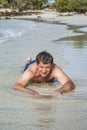 Man in bathingsuit is lying at the beach Royalty Free Stock Photo