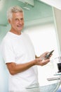 Man in bathroom applying aftershave