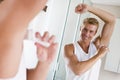 Man in bathroom applying deodorant Royalty Free Stock Photo