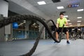 Man with battle ropes exercise in the fitness gym. Royalty Free Stock Photo