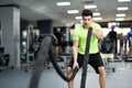 Man with battle ropes exercise in the fitness gym. Royalty Free Stock Photo