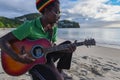 Man on the Beach in Grenada playing guitar