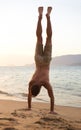 Man, beach and handstand for holiday travel on tropical island for ocean adventure, sunshine or weekend. Male person Royalty Free Stock Photo