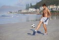Man, beach and playing with soccer ball for game, sports or exercise in outdoor hobby, training or practice. Young male Royalty Free Stock Photo