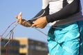 Man on the beach preparing kite lines. Men hands untie kitesurfing tangled lines. Demonstration how to untangle and prepare the