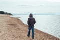 Man on the beach by the sea in cold weather Royalty Free Stock Photo