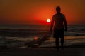 Man on the beach during sunrise