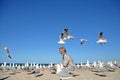 Man on beach surprized by flock of seagulls