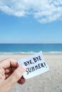 Man on the beach and text bye bye summer in a note Royalty Free Stock Photo
