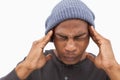 Man in beanie hat wincing with pain of headache Royalty Free Stock Photo