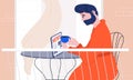 Man with beard in bath robe reading latest news on a tablet device and heaving his morning coffee at home on the balcony