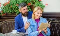 Man with beard and blonde woman cuddle on romantic date. Love and flirt. Common interests. Couple in love sit cafe Royalty Free Stock Photo