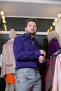 A man with beard in a blue shirt and gray trousers Royalty Free Stock Photo