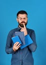 Man with beard and books. Notebooks in blue color Royalty Free Stock Photo