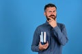 Man with beard and books. Notebooks in blue color Royalty Free Stock Photo