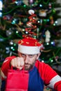 Man with beard in Christmas hat on background of tree Royalty Free Stock Photo