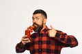 Man with beard drinks tomato juice on white background. Royalty Free Stock Photo