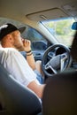 Man with beard is driving car, driver stuck in traffic jam Royalty Free Stock Photo