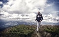 Man with beard enjoy freedom, runs on top of mountain. Hipster feels free while hiking, sky background. Man with brutal Royalty Free Stock Photo