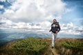 Man with beard enjoy freedom, runs on top of mountain. Hipster feels free while hiking, sky background. Man with brutal Royalty Free Stock Photo