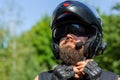 Man with a beard in a helmet. Close-up baker in a black helmet with a black beard