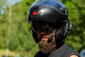 Man with a beard in a helmet. Close-up baker in a black helmet with a black beard