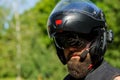 Man with a beard in a helmet. Close-up baker in a black helmet with a black beard