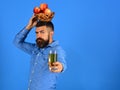 Man with beard holds bowl of fruit and juice
