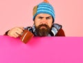 Man with beard holds brown cup of curing powder. Royalty Free Stock Photo