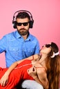 Man with beard holds lady on pink. Couple in love