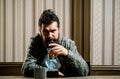 Man with beard holds glass brandy. Man holding a glass of whisky. Handsome stylish bearded man is drinking whiskey Royalty Free Stock Photo