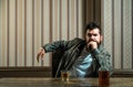 Man with beard holds glass brandy. Man holding a glass of whisky. Handsome stylish bearded man is drinking whiskey Royalty Free Stock Photo