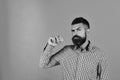 Man with beard holds red apple isolated on yellow background