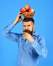 Man with beard holds wicker bowl of fruit and juice