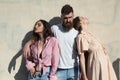 Man with beard hugs two ladies on hot sunny day. Girls turned to opposite sides while man hugs them. Love triangle Royalty Free Stock Photo