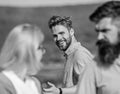 Man with beard jealous aggressive because girlfriend interested in handsome passerby. Husband strictly watching his wife Royalty Free Stock Photo