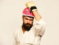 Man with beard in kimono and pink helmet on white Royalty Free Stock Photo