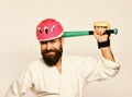 Man with beard in kimono and pink helmet on white background. MMA sports concept. Combat master gets ready to fight