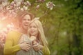 Man with girl or pretty woman at blossoming magnolia Royalty Free Stock Photo