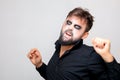 Man with a beard and makeup for Halloween grimaced Royalty Free Stock Photo