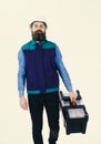 Man with beard and mustache holds toolbox on white