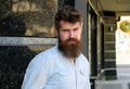 Man with beard and mustache on strict, serious or disgusting face, black marble background. Masculinity concept. Hipster Royalty Free Stock Photo