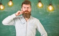 Man with beard and mustache on thoughtful face stand in front of chalkboard. Guy thinking with thoughtful expression Royalty Free Stock Photo