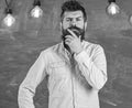 Man with beard and mustache on thoughtful face stand in front of chalkboard. Intellectual task concept. Guy thinking Royalty Free Stock Photo