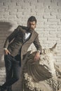 Man with beard and mustache on white brick wall background.