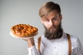 Man with a beard with a pie Royalty Free Stock Photo