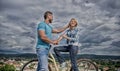 Man with beard and shy blonde girl on first date. Couple just meet to hang out together. Woman feels shy in company with