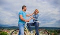 Man with beard and shy blonde girl on first date. Couple just meet to hang out together. Woman feels shy in company with