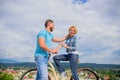 Man with beard and shy blonde lady on first date. How to meet girls while riding bike. Picking up girl. Couple just meet Royalty Free Stock Photo